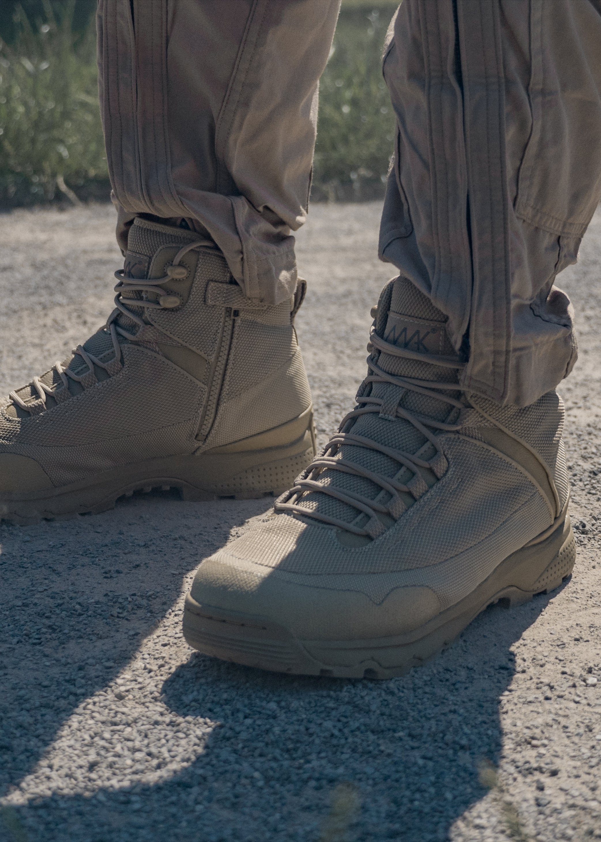 Mak delta x desert tan tactical boot standing on gravel